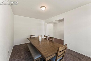 Dining area with carpet floors and baseboards