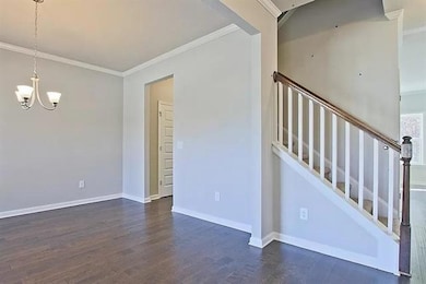 Stairway featuring a chandelier, ornamental moldin