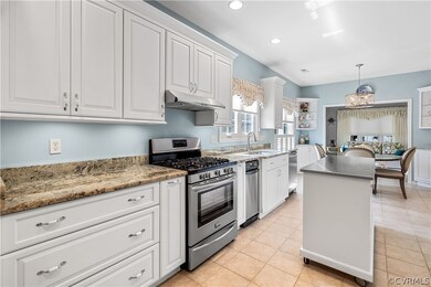 Wall of custom cabinets, Gas oven range, tile floo