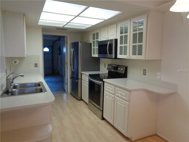 Galley kitchen has door to the garage