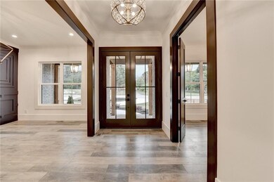 Foyer entrance featuring french doors, light wood 