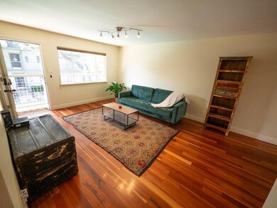 Living area with wood finished floors and baseboa