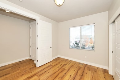 Unfurnished bedroom with light wood-type flooring and a closet