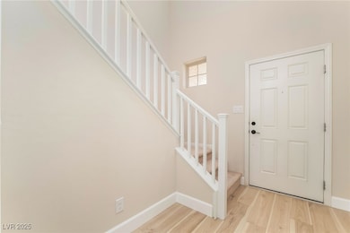 Entryway with stairway, light wood-style flooring,