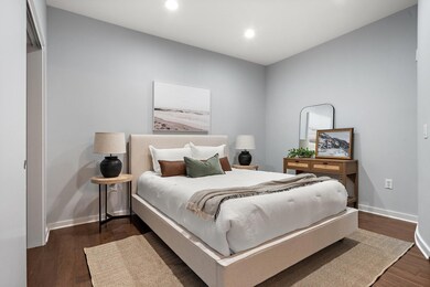 Bedroom featuring dark wood-type flooring, recesse