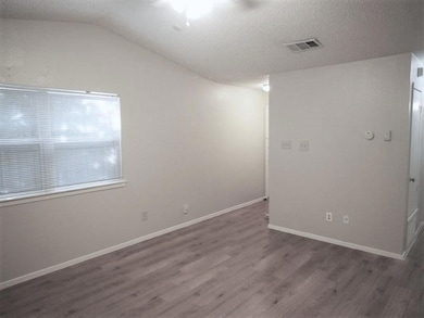 Unfurnished room with visible vents, baseboards, 