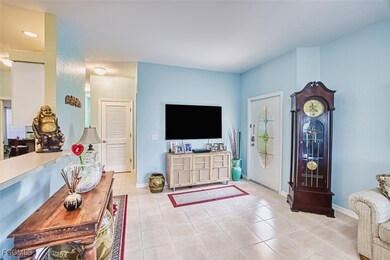 Living room featuring light tile patterned floors and baseboards