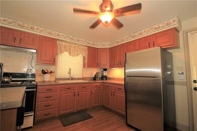The kitchen has a nice wood floor and a lighted pa