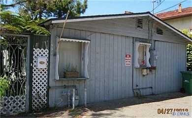 BACKSIDE OF THE COTTAGE WITH ONE PARKING SPACE.