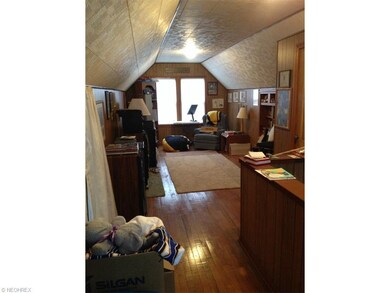Upper floor third bedroom with hardwood flooring