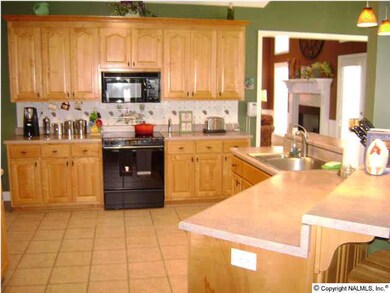 A CHEF'S DREAM KICTHEN WITH PLENTY OF CABINETS AND COUNTER TOPS AND A LARGE PANTRY.