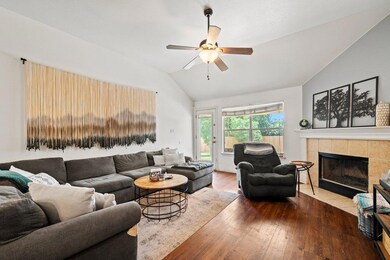 Living room featuring vaulted ceiling, wood finis
