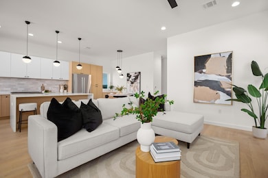 Living area with light wood-type flooring, basebo