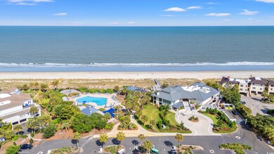Birds eye view of property with a water view and a view of the beach bar area and pool.