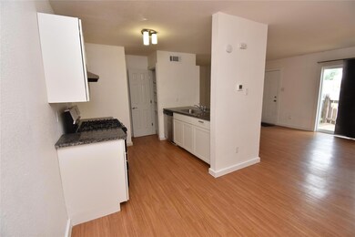 Kitchen featuring a sink, light wood-style floors