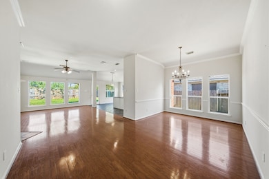 Open-concept living and dining area with hardwood floors.