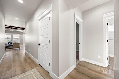 Hallway featuring light wood-style floors and recessed lighting