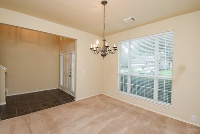 Te dining area with large windows, carpeted floor,
