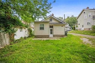 Back of property featuring a lawn