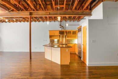 Kitchen featuring a sink, dark countertops, a cen