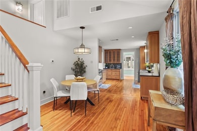 Dining area with vaulted ceilings open to the kitc