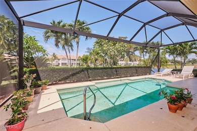 Outdoor pool featuring glass enclosure and a patio