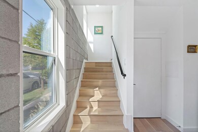 Stairway featuring hardwood / wood-style floors