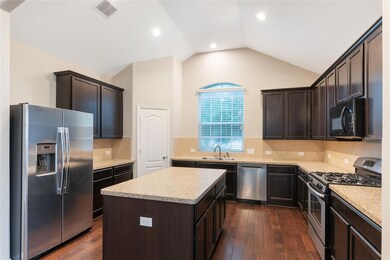 Kitchen with stainless steel appliances, dark bro