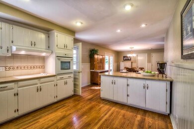 Recessed lighting, new cooktop & vent hood,  new built in oven & tiled backsplash are just a few of the features of this large, open kitchen.