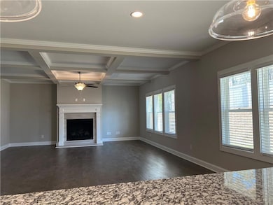 Unfurnished living room with ceiling fan, dark wood-style floors, beam ceiling, coffered ceiling, and recessed lighting