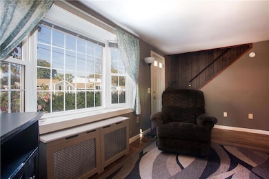 A large bay window fills the living...