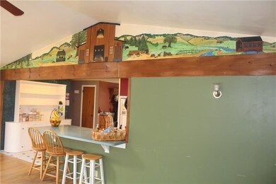 Family room with farmhouse mural opens to the kitc