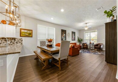 Dining space featuring recessed lighting, dark woo