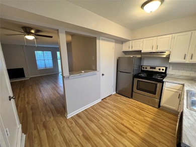 Spare room featuring baseboards, a ceiling fan, an