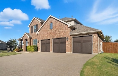 View of front of home featuring driveway, brick siding, roof with shingles, and an attached garage