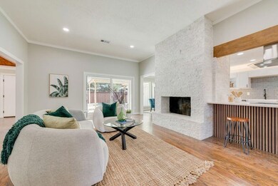 Living room featuring visible vents, light wood-st