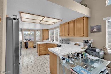 Kitchen featuring freestanding refrigerator, a pen