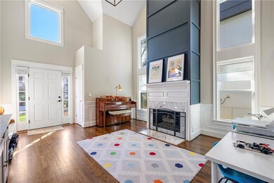 Entry/living area with vaulted ceiling, fireplace,