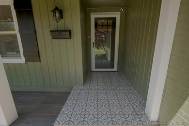 Decorative tile leads to the front door.