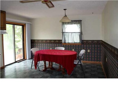 DINING AREA IN KITCHEN FEATURES PATIO DOORS