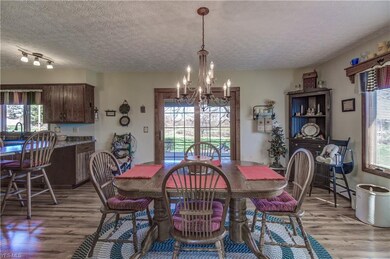 SPACIOUS DINING AREA WITH NEWER LAMINATE FLOORING.