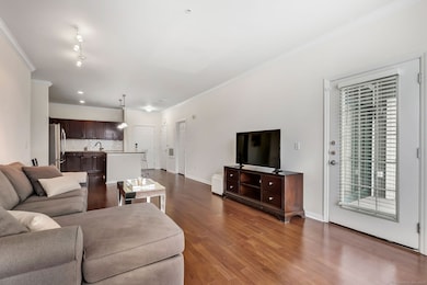 Living room overlooking kitchen with access to bal