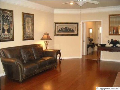 Another View of Greatroom with Hardwood Floors, Fireplace, Crow Molding, Ceiling Fan