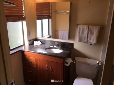 Remodeled master bathroom features new cabinet and slab granite counter top.