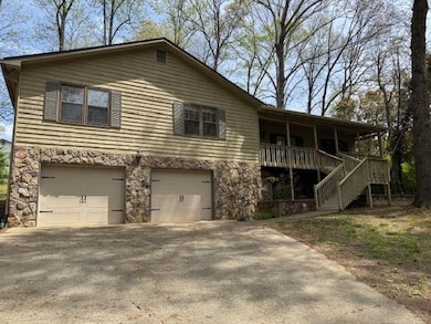 View of front of house with stone siding, a garage
