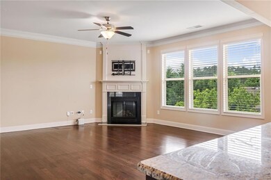 Living room with ceiling fan, a tile fireplace, da