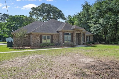 View of front of home with brick siding, a front y