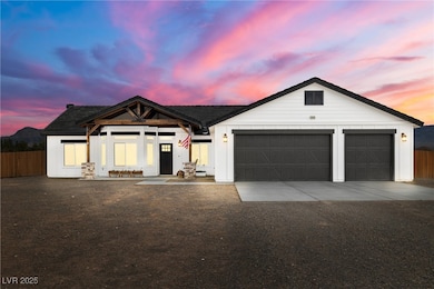 View of front of home with concrete driveway, fenc