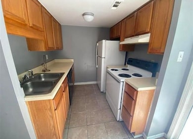 Kitchen featuring white electric range oven, sink,
