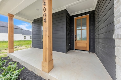 View of exterior entry featuring covered porch